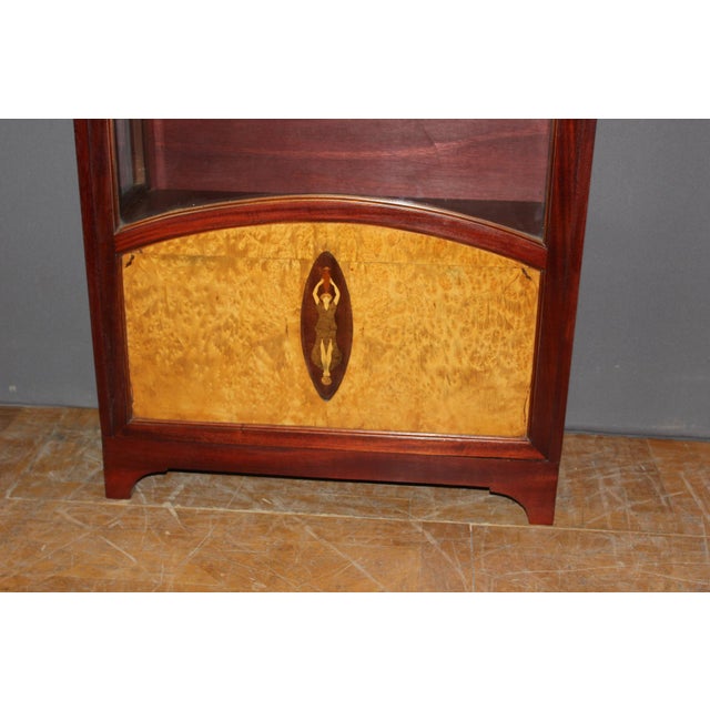 Small Art Deco period display cabinet in mahogany and burr wood, it opens with a door, marquetry on the door depicting a...
