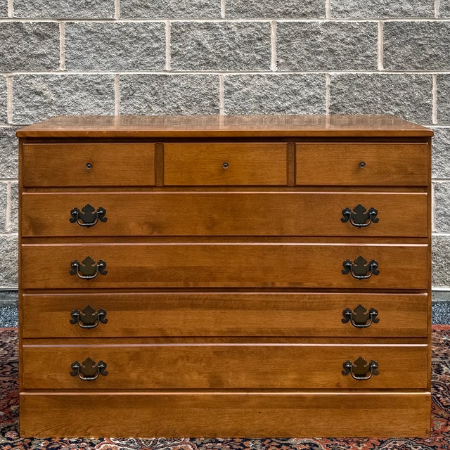A vintage Ethan Allen Heirloom Maple collection American Traditional solid maple low dresser having a solid maple top over...