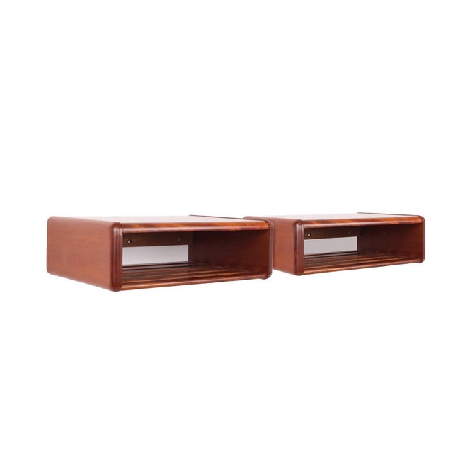 Set of 2 wall bedside tables with integrated magazine rack, made of solid wood in the 1960s in denmark. these beautiful...