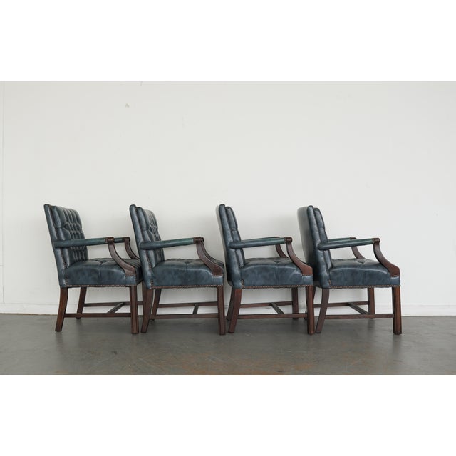 A handsome set of four vintage leather armchairs Attributed to Hickory Leather Co., crafted with the quality and...