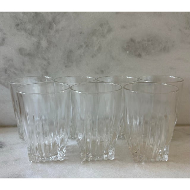 Set of 7 vintage mid century small juice glasses featuring sqaure bottoms and vertical ribs around the lower half that...