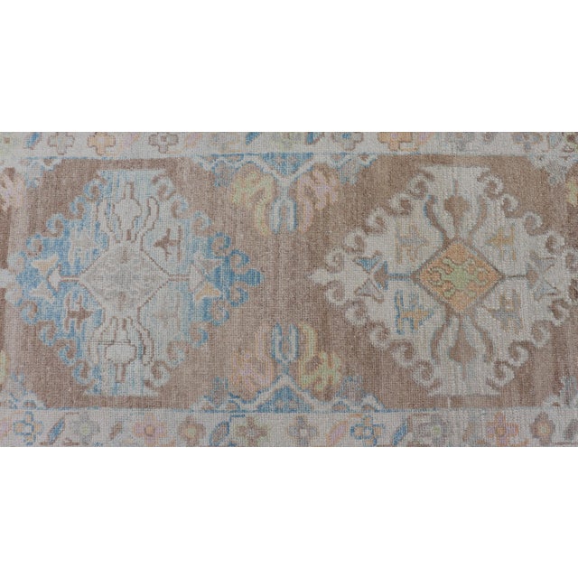 Long Turkish Oushak Runner With Pale Blue, Soft Yellow, and Light Brown Motifs For Sale In Atlanta - Image 6 of 13