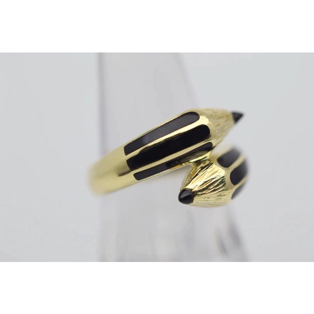 A sweet, fun and stylish ring designed as a double ended pencil! It is finely crafted in 18k yellow gold with hand-carved...