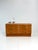 A compact chest of drawers in a mid-century-inspired retro style with six drawers and a warm wood finish. The clean,...