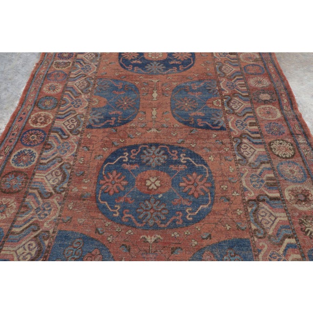 Hand-knotted in natural silk circa 1910-1920, this 6x11 antique Khotan rug is a rare and distinguished example of East...