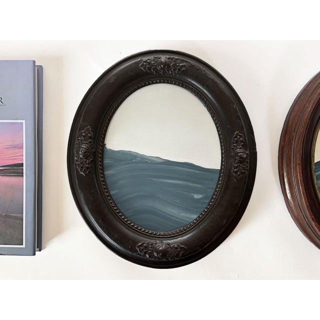 Step into a moment of stillness with "Porthole XIX” Housed in an intricately detailed antique frame, this piece evokes a...