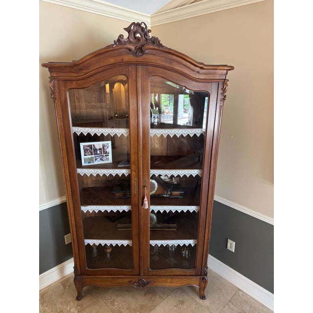 Add timeless sophistication to your home with this stunning French Provincial-style curio cabinet / display hutch. Crafted...