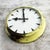 Large factory clock with domed metal case in cream-yellow painted finish. The 60cm diameter frame houses a white dial...