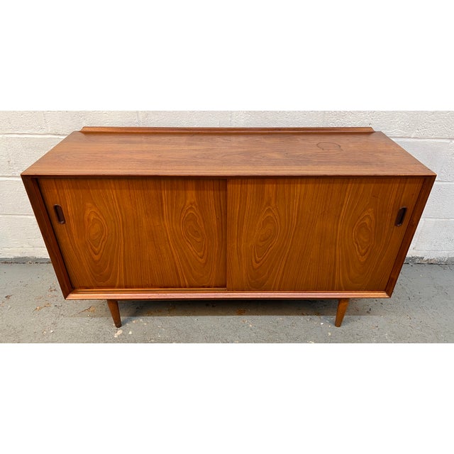 An iconic Mid-Century Danish Modern credenza designed by renowned Danish designer Arne Vodder for Sibast Møbler....