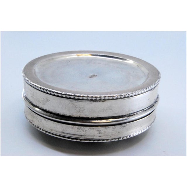 Circular Silver Box with Embossed Flowers on the Lid, in Very Good conditions. Designed 1920 to 1949 This piece has an...