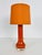 A beautiful large table lamp made in the 1960s. The base is made of heavy orange colored glass. The lamp shade is made of...