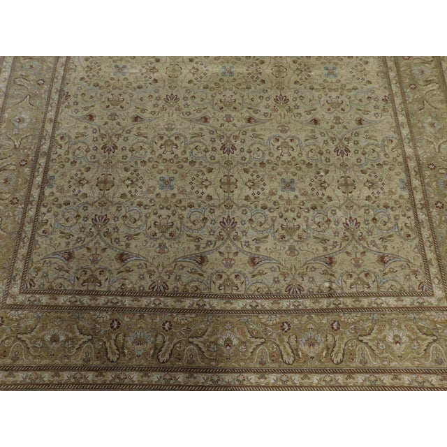 All over floral field within light brown border. 100 % pure wool pile on cotton foundation. Hand made.
