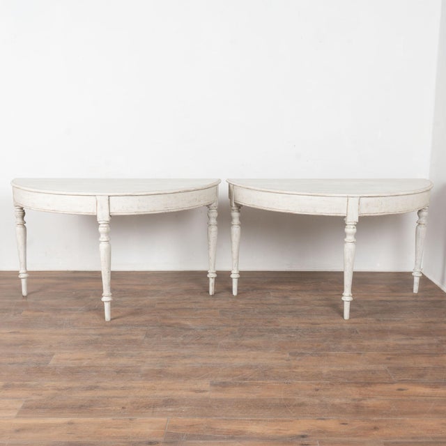 Pair, Gustavian large demi-lune side tables or consoles that are each just over 4.5' wide at back. Turned legs add to the...