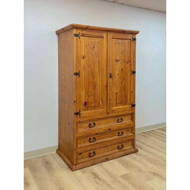 This handsome large vintage Mexican knotty pine armoire is a beautifully crafted and characterful rustic wardrobe find....