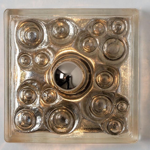 A peill & putzler wall or ceiling light in sculptural glass, circa 1970s, germany. Statement piece. A clear design, with...