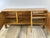 Solid elm sideboard by Maison Regain, 1970. The front features three doors with horizontal and vertical wood joinery. The...