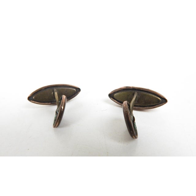 Antique gold filled with carved mother of pearl bezel set cufflinks. Marquise shape, some wear to backing.