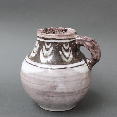A decorative ceramic pitcher with stylised plant motif by st. Aignan pottery (circa 1970s). The st. Aignan pottery is...