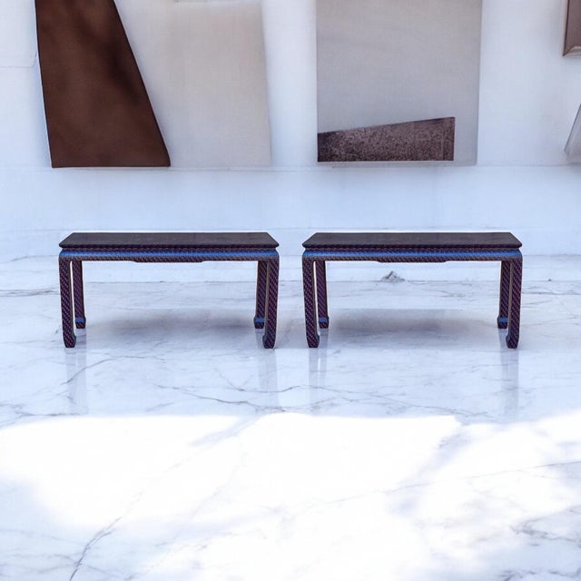 This is a pair of Ming style grasscloth wrapped console tables attributed to Baker Furniture Company. They both are in...