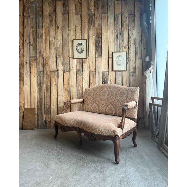 This late 19th-century louis xv style two-seater bench is distinguished by its low profile, cabriole legs, and carved...