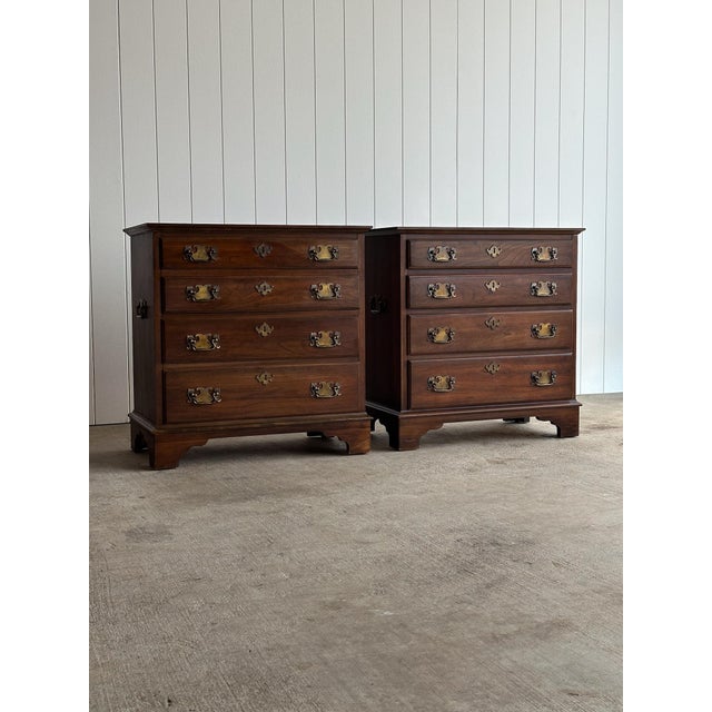 Pair of Georgian bachelor chests or nightstands. Each chest features four graduated drawers with original brass hardware,...