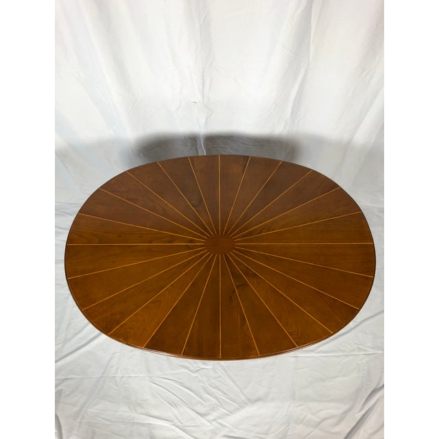 Beautiful oval pedestal table. Circa 1930 French polished walnut and ebony inlaid top mounted on leather finished base