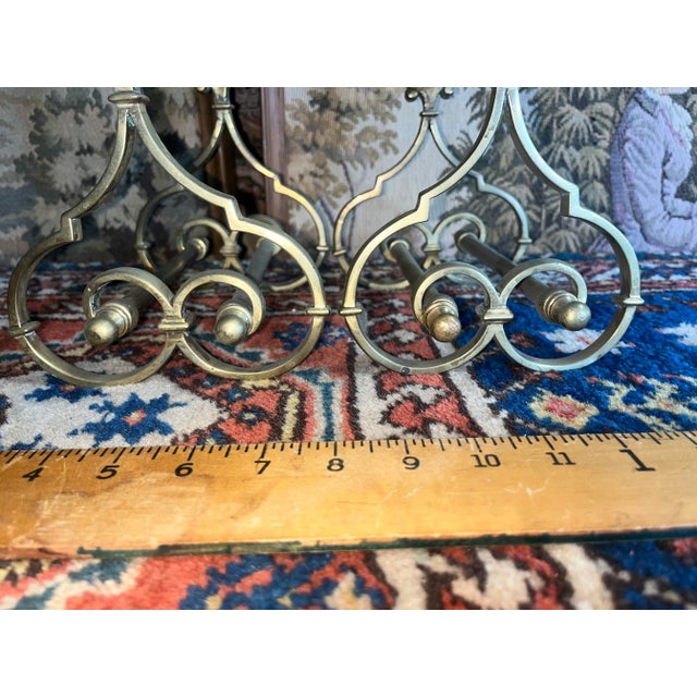 A very nice pair of smaller size English solid brass andirons. Beautifully scrolled legs with nice finials front and back.