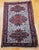 This exceptional Antique Caucasian Soumak area rug features a striking three-medallion design in rich shades of red, blue,...