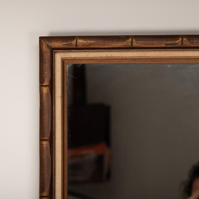 A 1950's Giltwood bamboo style linen wood framed mirror, sized 28" x 40". A large vintage piece, perfect for adding a...