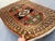 A bold hand-knotted Caucasian Kazak rug in the Sevan Star triple medallion format — two green-framed octagonal star...