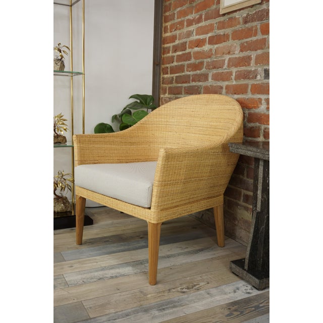 Pair of armchairs with teak frames and rounded, hand-woven rattan seats. Comfortable and in perfect condition.