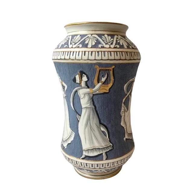 A stunning, vintage hand painted Majolica vase. Features a Neoclassical design with figures encircling the body in shades...