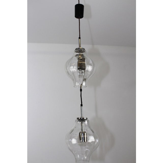 This ceiling lamp, model Tulipan, consists of two large blown glass shades with small air bubbles and a metal support. The...