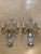 A pair of circa 1930’s silver leaf metal sconces with glass leaves and body
