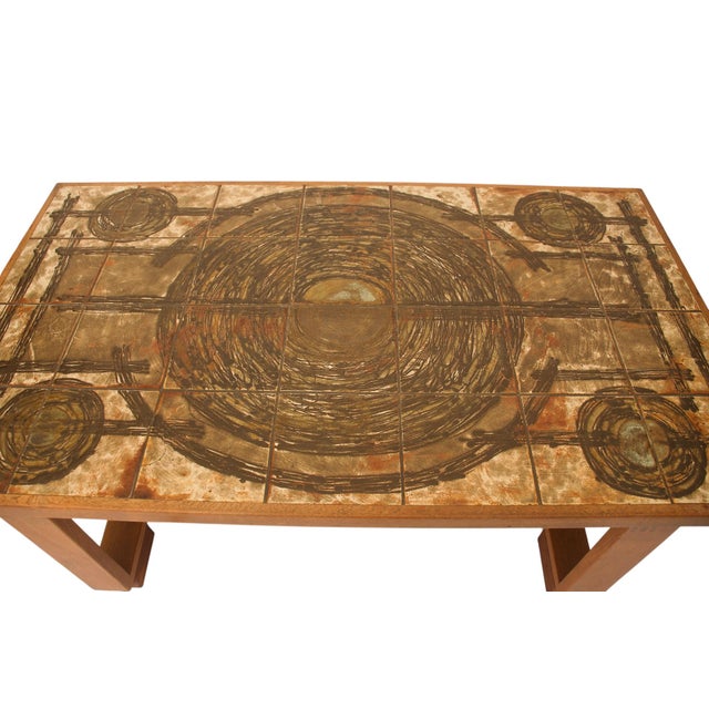 Ceramic art tiles on top of a solid teak base. Very nice wooden connections and the table is in excellent condition. This...