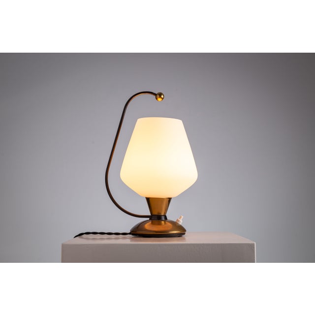 Elevate your interior with this striking mid-century table lamp, where form meets function in the most elegant way....