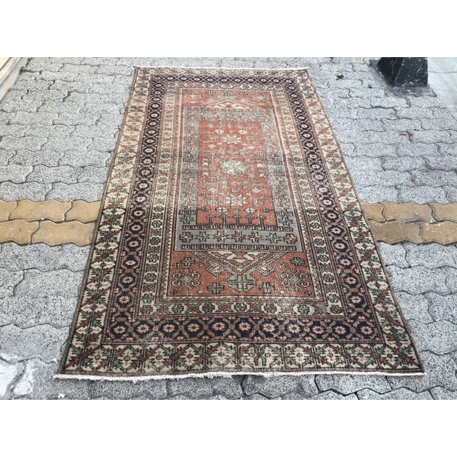 This is a vintage Turkish Oushak rug from the 1960s. The piece was hand-knotted.
