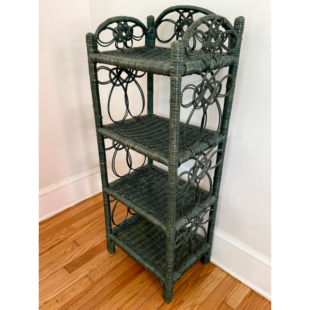 Pretty green wicker shelf with four tiers. Please see condition details noted. Height between shelves is 9.5". Most items...