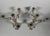 Pair of Rococo Candelabra in 950 Sterling Silver. In the 18th-century Louis XV style. The circular base with contoured...