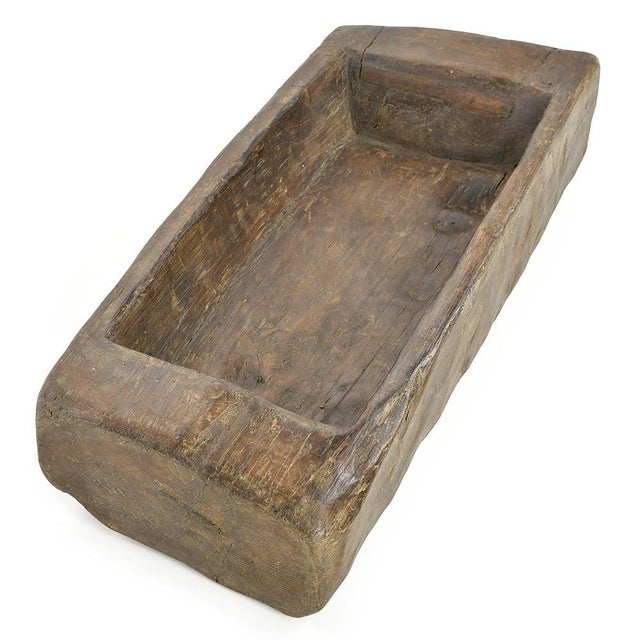 Carved from a single piece of solid wood, this antique trough embodies traditional craftsmanship in all its robust...