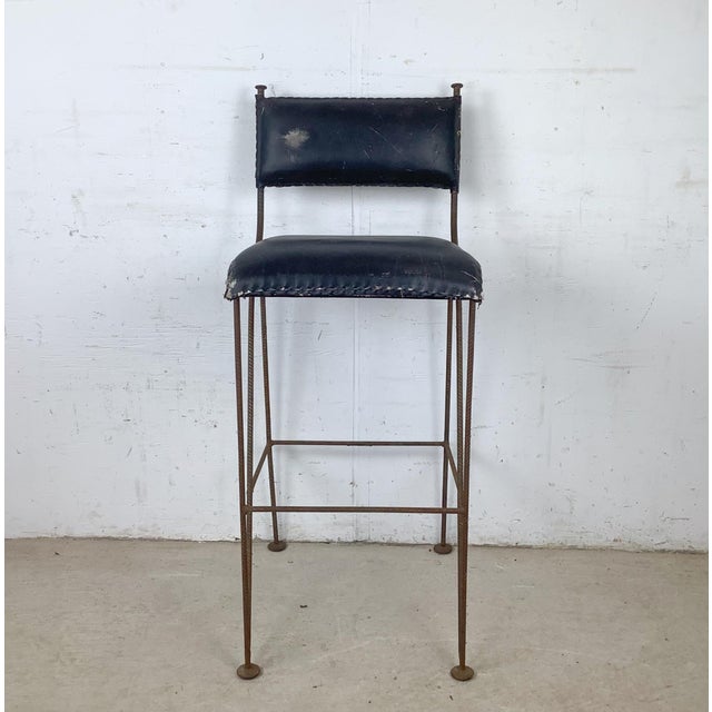 An exceptionally sculptural studio-made iron counter stool dating to the mid-20th century, likely produced during the...