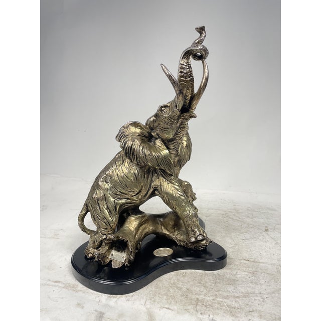 Beautiful silver-plated sculpture with wooden base, depicting an elephant. Excellent decorative item