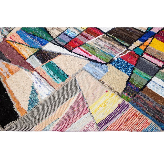 Beautiful Tulu handmade wool rug with a multicolor field. This Vintage rug has beige small fringes featuring a gorgeous...