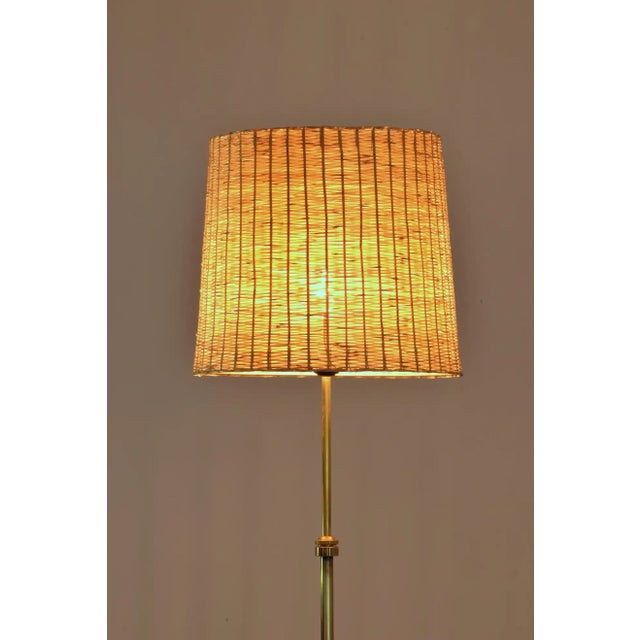 The Ancora floor light stands on a slender brass structure and a sophisticated disk base. The shade is delicately...