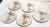 Pretty set of five vintage Fitz & Floyd salad plates. Each is made of white porcelain with a coral color conch shell...