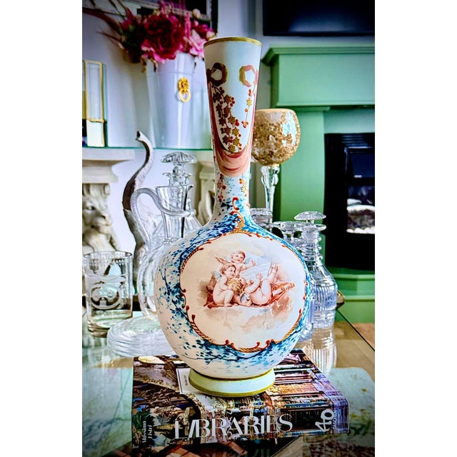 Decorative set of two French opaline glass vases from the 19th century. The opaque glass bodies are hand-painted with...