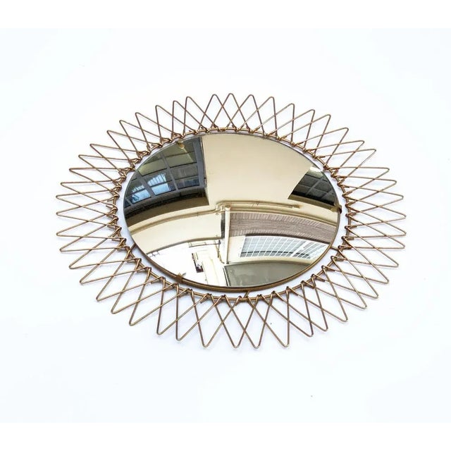 Elegant French sunburst-shaped mirror, produced in France during the late 1970s. This amazing round wall mirror has a...