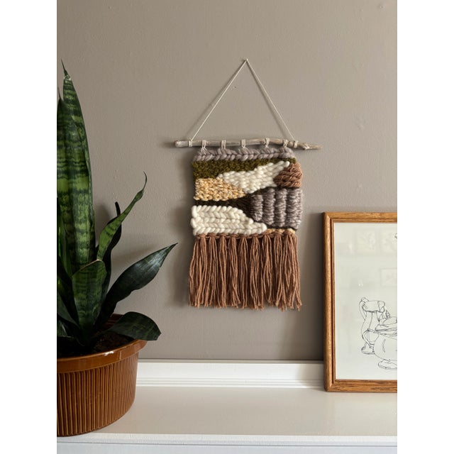 Handwoven with rich textures and natural tones, *Woodland Drift* evokes the tranquility of a forest floor. Featuring...