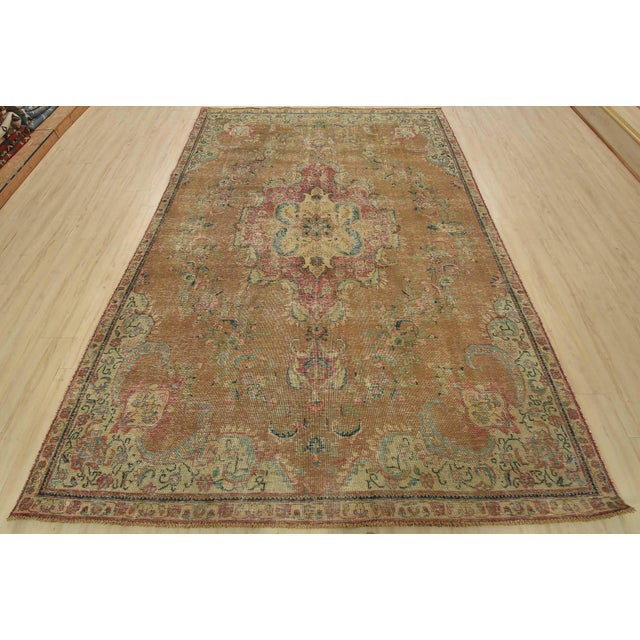 An authentic vintage traditional Tabriz rug hand-knotted with fine wool and natural dyes. This rug features a central...