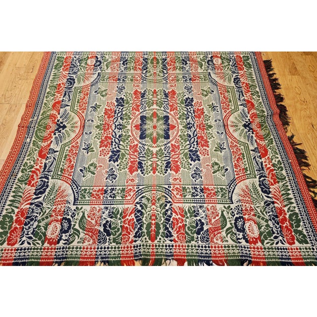 This mid-19th century American coverlet is a stunning handwoven textile created on a Jacquard loom, featuring a rich...